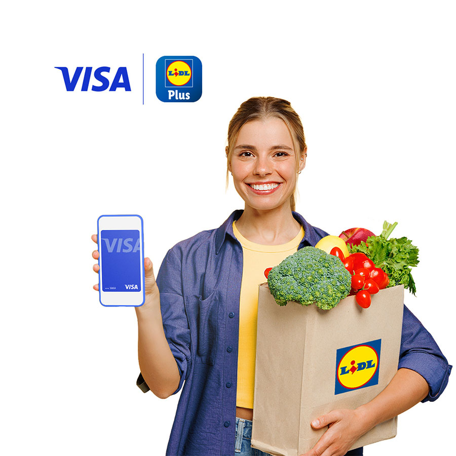 woman holding lidl shopping with Visa card on mobile