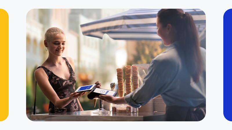 woman paying by phone at restaurant