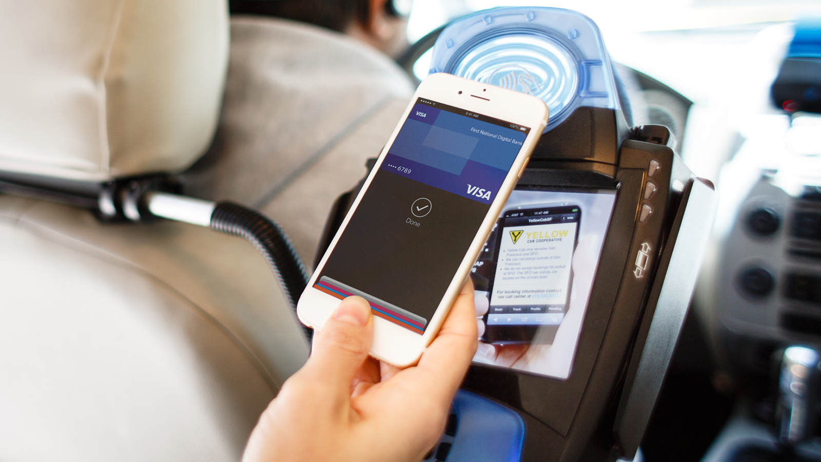 Using Apple Pay at a contactless-enabled terminal inside a taxi.