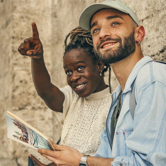 man and woman sat smiling on holiday